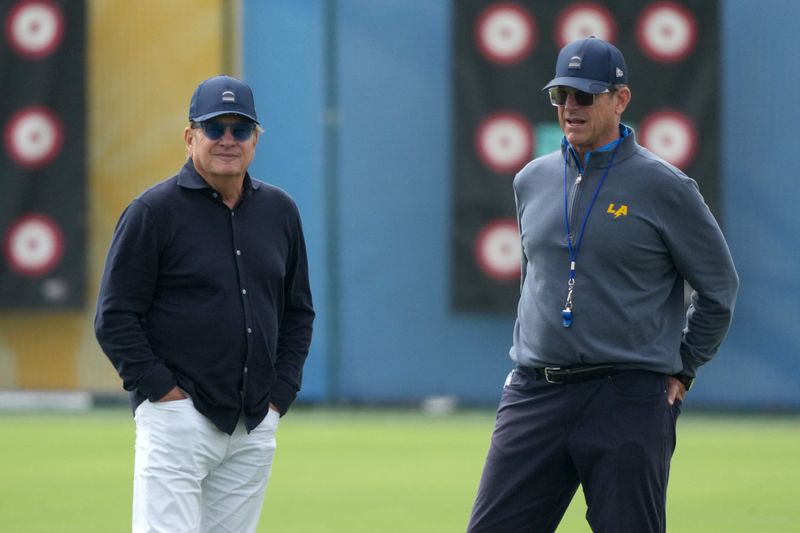 May 11, 2026; El Segundo, CA, USA; Los Angeles Chargers owner Dean Spanos (left) and coach Jim Harbaugh watch during offseason workouts at The Bolt. Mandatory Credit: Kirby Lee-Imagn Images