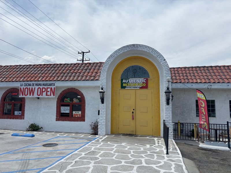 A "Now Open" sign hangs on the exterior of the new La Cocina De Mama Margarita restaurant in Cathedral City.