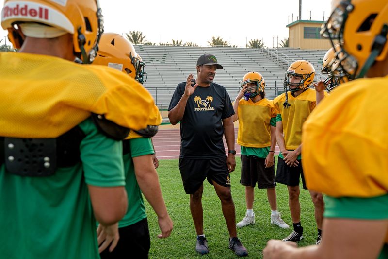 Coachella Valley High School football head coach Bill Johnson talks to the players during practice at the school in Thermal, Calif., on Tuesday, August 11, 2026.