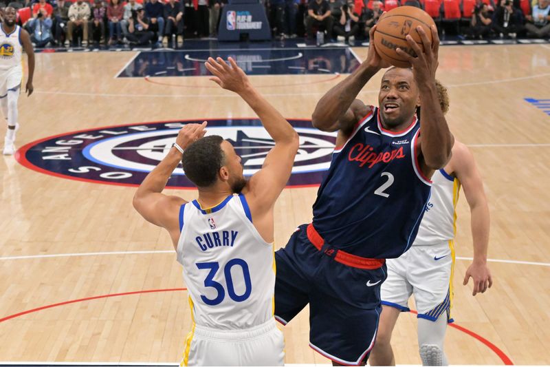 Apr 15, 2026; Inglewood, California, USA; Los Angeles Clippers forward Kawhi Leonard (2) shoots past Golden State Warriors guard Stephen Curry (30) in the first half during the play-in rounds of the 2026 NBA Playoffs at Intuit Dome. Mandatory Credit: Jayne Kamin-Oncea-Imagn Images