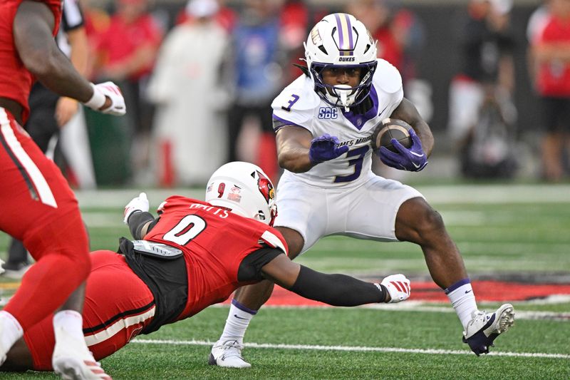 James Madison Dukes running back Wayne Knight (3) tries to avoid the tackle of Louisville Cardinals linebacker Antonio Watts (9) during the first half at L&N Federal Credit Union Stadium.