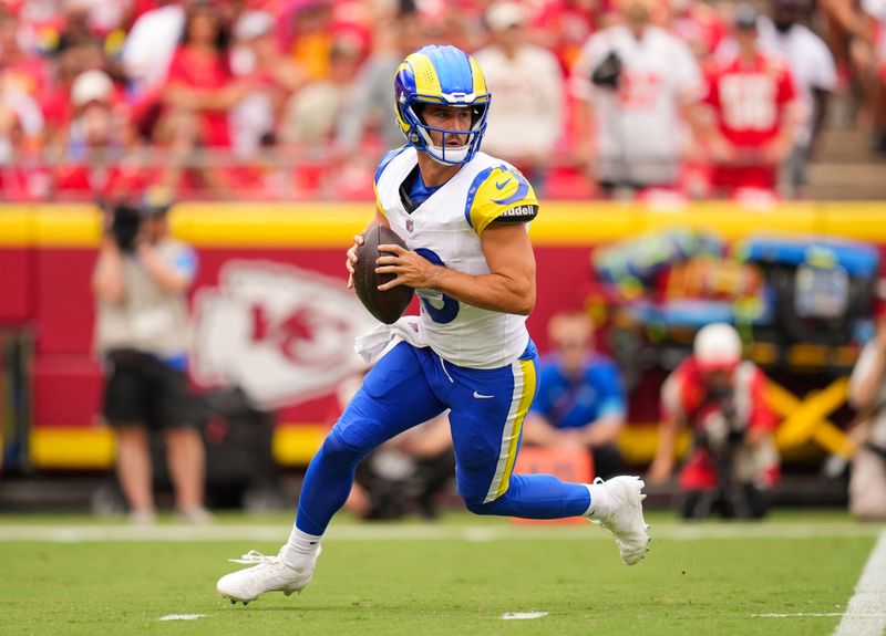Aug 15, 2026; Kansas City, Missouri, USA; Los Angeles Rams quarterback Stetson Bennett IV (13) rolls out to pass during the first half against the Kansas City Chiefs at at Arrowhead Stadium. Mandatory Credit: Jay Biggerstaff-Imagn Images