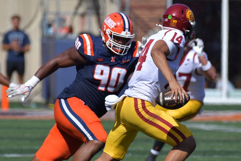 Sep 27, 2025; Champaign, Illinois, USA; Southern California Trojans quarterback Jayden Maiava (14) runs with the ball as Illinois Fighting Illini defensive lineman James Thompson Jr. pursues during the second half at Memorial Stadium. Mandatory Credit: Ron Johnson-Imagn Images