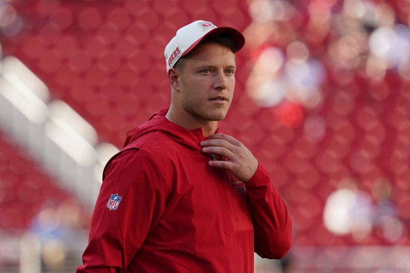 Aug 13, 2026; Santa Clara, California, USA;  San Francisco 49ers running back Christian McCaffrey (23) watches warmups before a preseason game against the Tennessee Titans at Levi's Stadium. Mandatory Credit: David Gonzales-Imagn Images