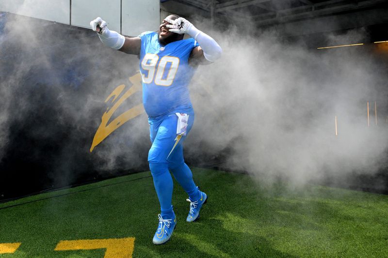 Oct 5, 2025; Inglewood, California, USA;  Los Angeles Chargers defensive tackle Teair Tart (90) runs on to the field for the game against the Washington Commanders at SoFi Stadium. Mandatory Credit: Jayne Kamin-Oncea-Imagn Images