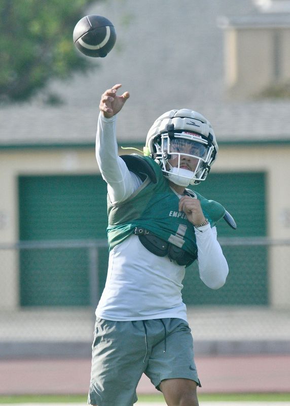 Dinuba High School quarterback Tony Ibarra passes at practice on Aug. 11, 2026 in Dinuba.