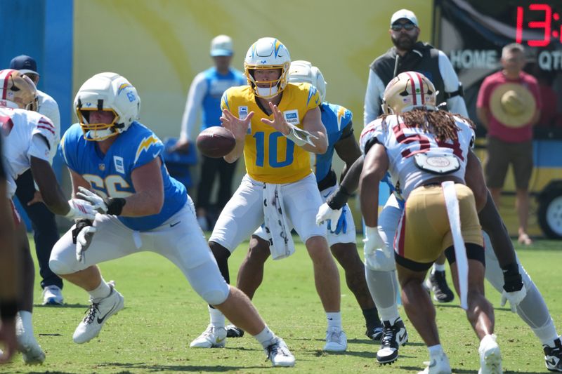 Aug 18, 2026; El Segundo, CA, USA; Los Angeles Chargers quarterback Justin Herbert (10) takes the snap from center Jake Slaughter (66) during joint practice  against the San Francisco 49ers at The Bolt. Mandatory Credit: Kirby Lee-Imagn Images