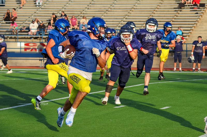 Anderson receiver Connor Bushey carries the ball during a three-team scrimmage including Trinity and Central Valley High Schools. Bushey is one of the Cubs top players heading into the 2026 football season. Aug. 14, 2026.
