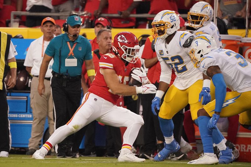 Sep 15, 2022; Kansas City, Missouri, USA; Kansas City Chiefs fullback Michael Burton (45) runs the ball against Los Angeles Chargers safety Derwin James Jr. (3) and linebacker Khalil Mack (52) during the first half at GEHA Field at Arrowhead Stadium. Mandatory Credit: Denny Medley-USA TODAY Sports