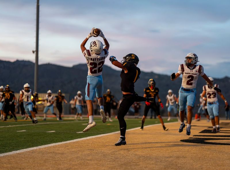 Rancho Mirage's Alexsander Gonzales catches an interception intended for Yucca Valley receiver Aiden Pope during the second quarter of the game in Yucca Valley, Calif., Friday, Aug. 21, 2026.