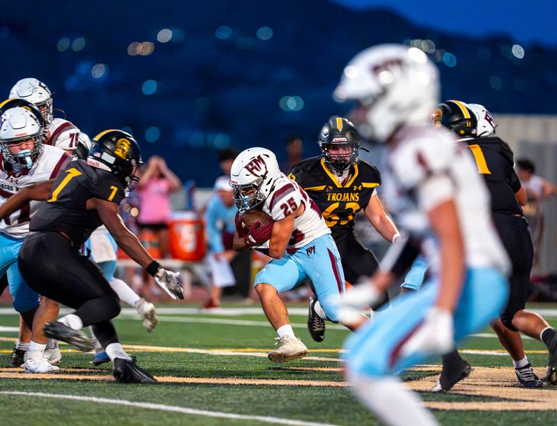 Rancho Mirage's Bentley Arredondo runs the ball during the second quarter of the game in Yucca Valley, Calif., Friday, Aug. 21, 2026.