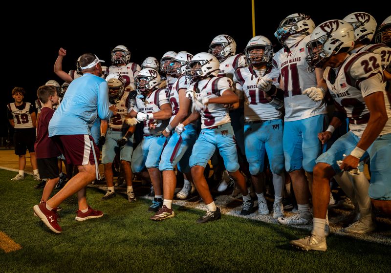 Rancho Mirage head coach L.D. Matthews. celebrates a win with his team after their game in Yucca Valley, Calif., Friday, Aug. 21, 2026.