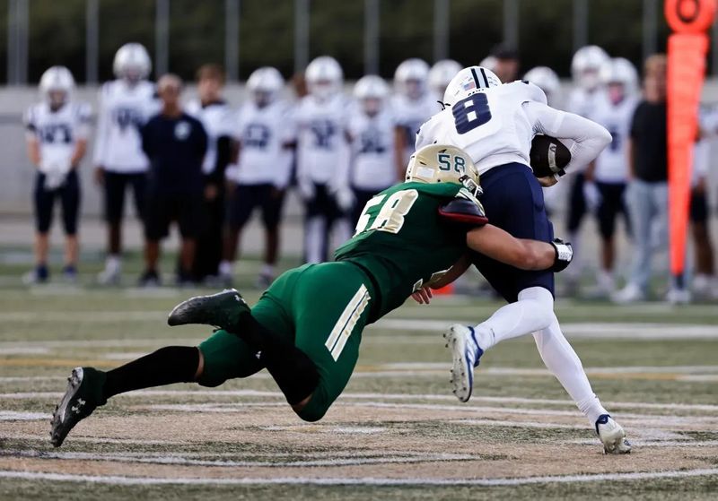 Camarillo High quarterback Brad Barlow tries to get loose of Santa Barbara's Lucas Blessing during the Scorpions' 17-16 win in a season-opening nonleague game in Santa Barbara on Friday, Aug. 21, 2026.