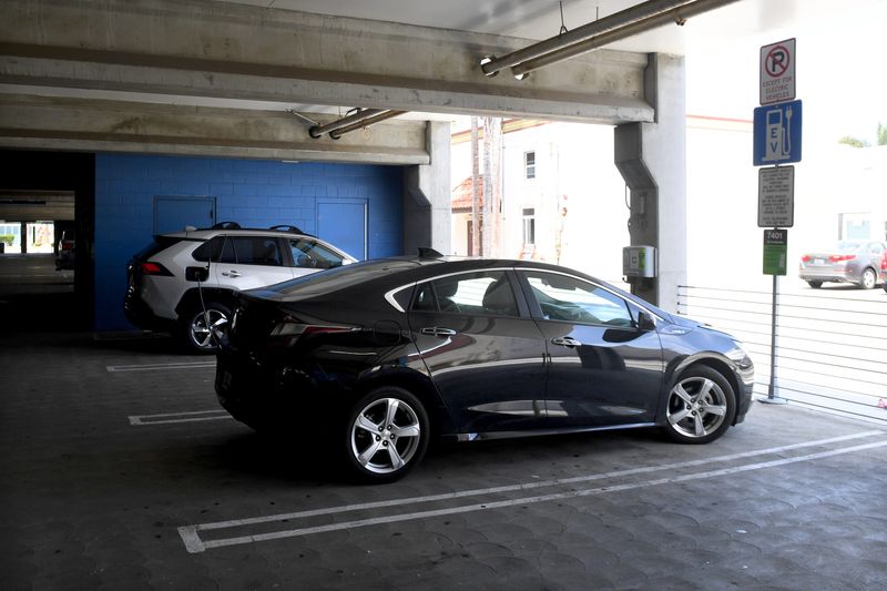 A car recharges at an electric vehicle charging station in downtown Oxnard in 2022.