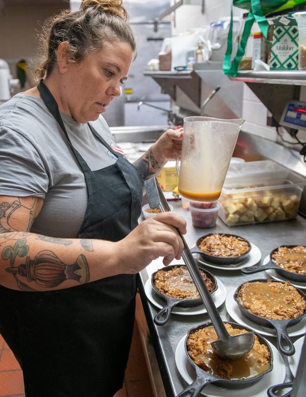Pastry chef Dawn Thomas prepares bourbon bread pudding with whiskey cream sauce, vanilla ice cream, and candied pecans at South Market's new location at 905 East Gregory Street in Pensacola on Tuesday, July 12, 2022.