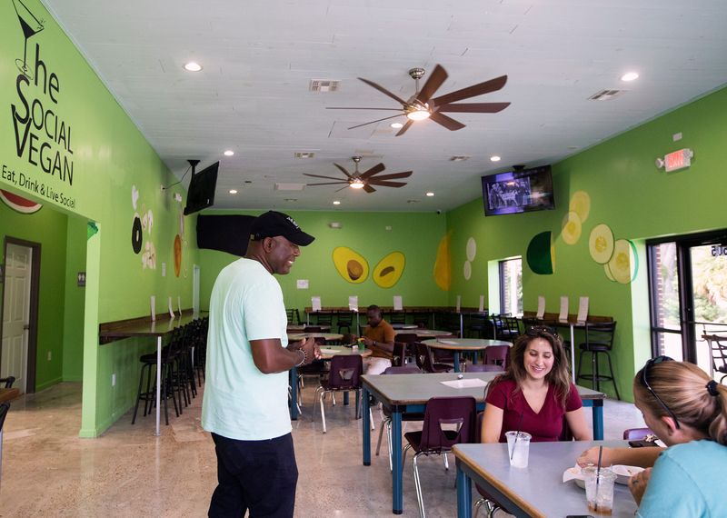 The Social Vegan co-owner Frank Hall talks to customers on Friday, Sept. 16, 2022.