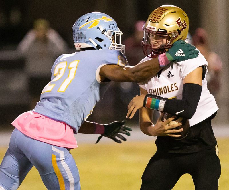 Chiefland Indians defensive end Jon Adams (21) sacks Florida State University High School quarterback Jeremy Johnston (15) in the first half. The Chiefland Indians hosted Florida State University High School in a battle of unbeaten football teams at Chiefland Middle High School in Chiefland, FL on Friday, October 21, 2022. Florida State University High School lead 21-14 at the half.  [Doug Engle/Ocala Star Banner]