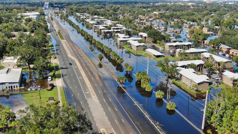 After Hurricane Ian was done thrashing Florida and pushed out into the Atlantic Ocean, Daytona Beach's Midtown neighborhood remained under water for days. Pictured is Nova Road looking north and the Midtown neighborhood to its east still swimming in floodwater surrounding the two-story Gardens of Daytona apartment buildings and one-story Caroline Village public housing units.
