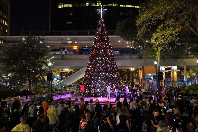Fans take in the lights of the City of Jacksonvllle's Christmas Tree after Wednesday evening's lighting ceremony. The final ArtWalk of 2022 featured the lighting of the City of Jacksonville's 56-foot Christmas tree in James Weldon Johnson Park with dancers entertaining the waiting crowd and live music after the lighting ceremony Wednesday, December 7, 2022. [Bob Self/Florida Times-Union]