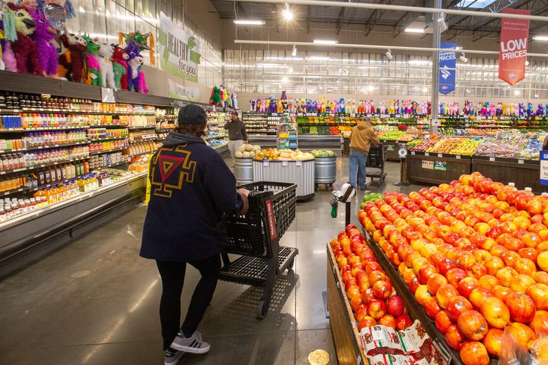 Shoppers push grocery carts within the produce section of Roeland Park's Price Chopper Monday morning.
