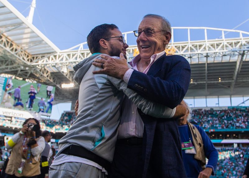 Miami Dolphins head coach Mike McDaniel embraces Dolphins owner Stephen Ross after the Dolphins beat the New York Jets at Hard Rock Stadium on Sunday, January 8, 2023, in Miami Gardens, FL.