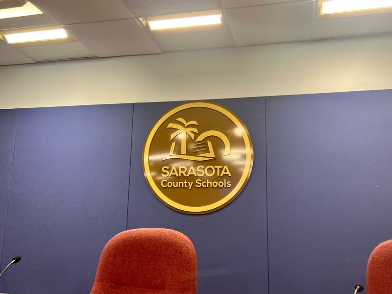 The Sarasota County Schools logo as seen from behind the School Board table. PHOTO: Steven Walker/Sarasota Herald-Tribune