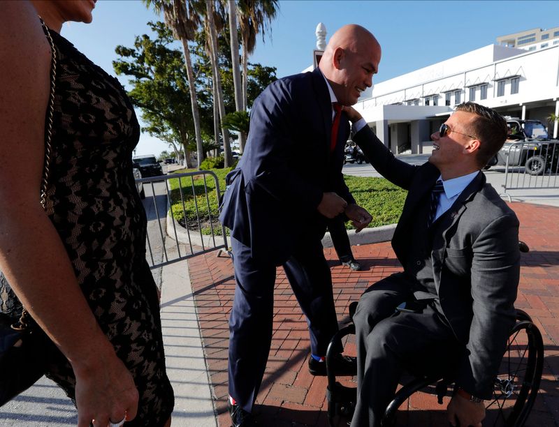 Former Ultimate Fighting Championship (UFC) light heavyweight champion Tito Ortiz, center, greets former U.S. Representative Madison Cawthorn after arriving to Downtown Fort Myers. Former President Donald J. Trump visits  downtown Fort Myers Friday, April 21, 2023 for a fundraising event and dinner at the Caloosa Sound Convention Center as supporters and protesters gather outside during the event.The event is part of the Lee County Republican Party's 2023 Lincoln Reagan Dinner.  Joining Trump are Lee County GOP Chair Michael Thompson, Congressman Byron Donalds, Congressman Greg Steube, and political strategist Roger Stone.