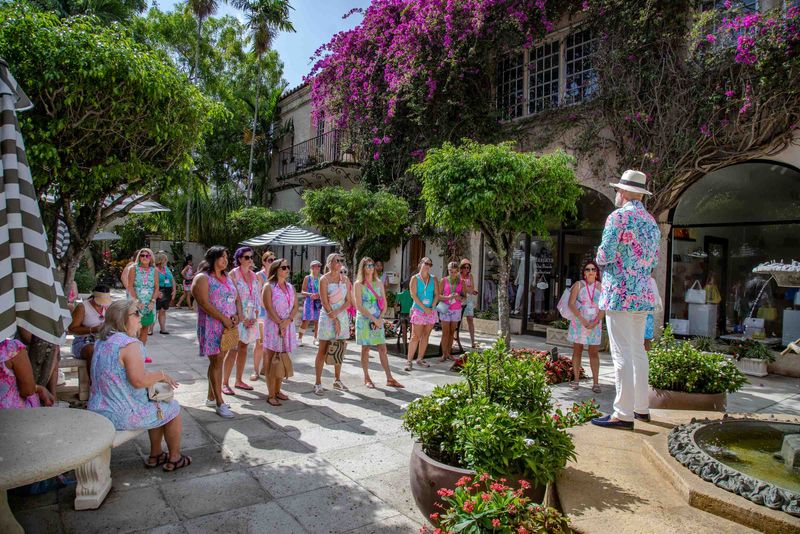 Women at the 2023 Pink Retreat take Rick Rose's popular tour of Worth Avenue, which explores the avenue's origins, unique architecture, legendary landmarks, and some of its famous residents.