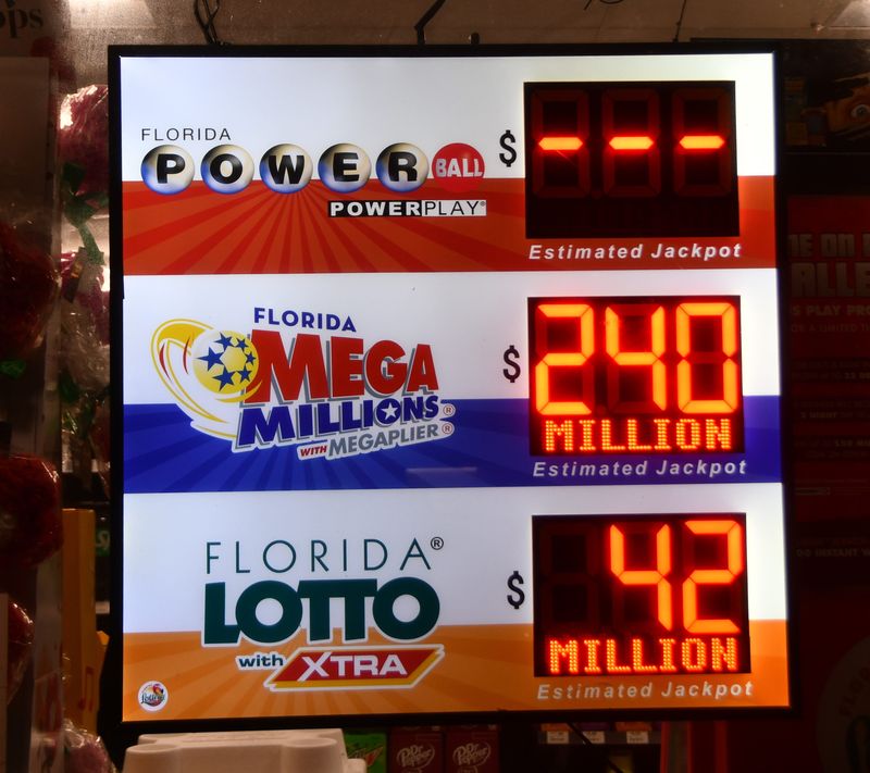 Signs in convenience stores show jackpot totals for Florida Lotto, Powerball and Mega Millions.