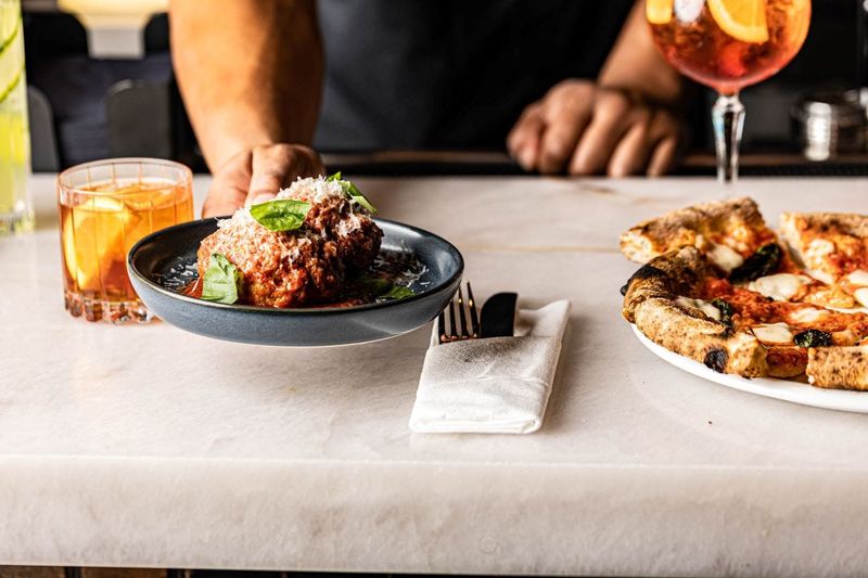 Adrienne's Pizzabar, which opened in 2023, was later joined by its sibling restaurant Harry's at The Square in West Palm Beach. Both restaurants have New York origins.