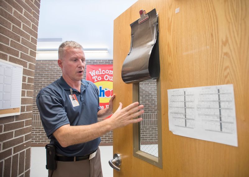 Daniel Hahn, Santa Rosa County School District director of safety, points out that all rooms have shades to cover door windows at Bennett C Russell Elementary School in Milton on Tuesday, June 4, 2019.  In the case of a lockdown, this will prevent anyone from seeing inside the room.