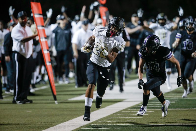 The Colony junior wide receiver Christian Gonzalez (22) runs past Frisco Independence senior defensive back John McGraw (14) during the first half of a high school football game at Memorial Stadium in Frisco, Friday, November 2, 2018. (Brandon Wade/Special Contributor Dallas Morning News)