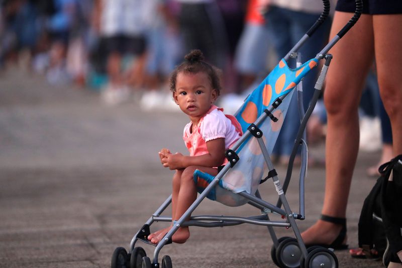 Oshuen Martin, 1, patiently waits in her stroller while her mother stands in line to audition for American Idol at Tucker Civic Center.