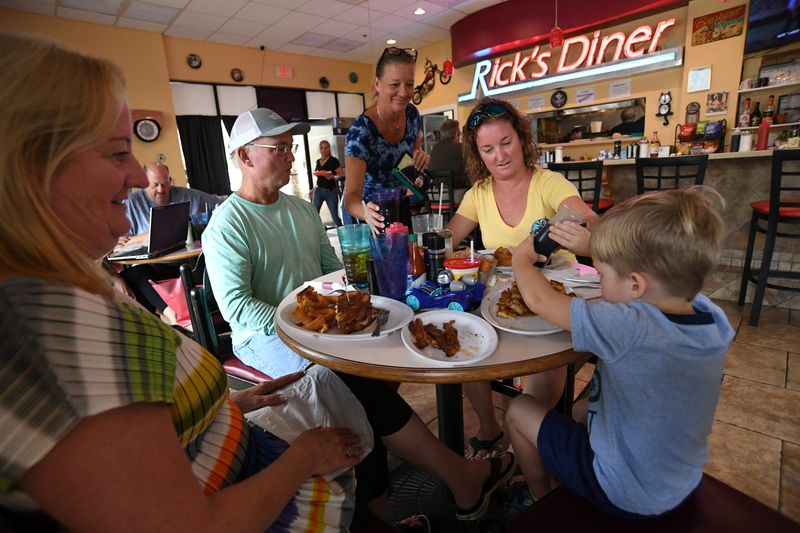 Server Cheryl Wise (center) serves her customers (from left) Vicky and Steve Hornbecker, their daughter Brooke Burton, and Brooke’s son, Laythan, 3, all of from Port St. Lucie, during lunch at Rick’s Diner Wednesday, Sept 4, 2019, in Port St. Lucie.