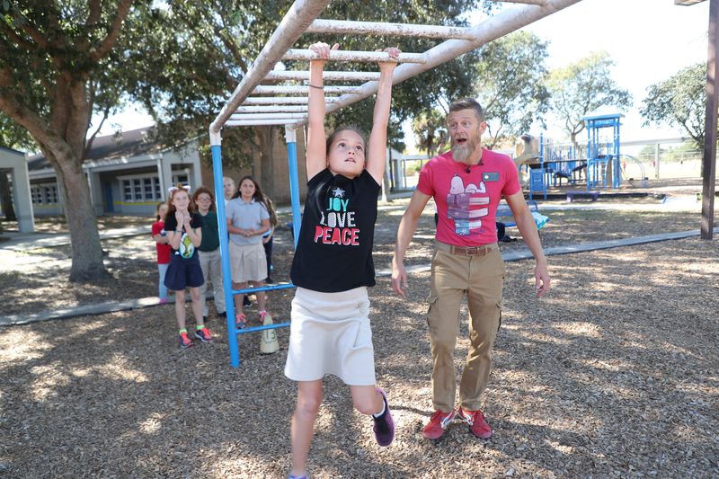 Former Diplomat Elementary School teacher Morgan Wright, also known as Morgan the "Moose" on the TV show "American Ninja Warrior" is suing the Lee School District after it suspended him, then reassigned him after social media comments about a slain conservative activist. He's shown in this 2018 file photo.