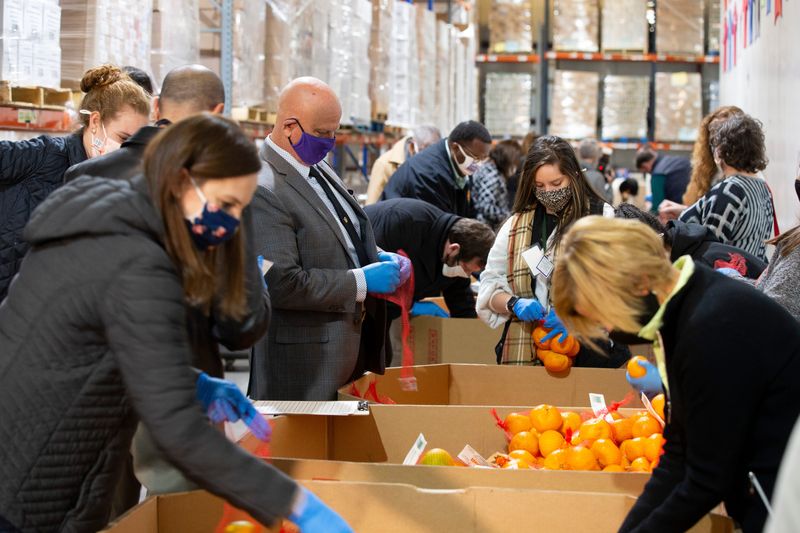 Hundreds of satsumas were put into bags for distribution kits by local and state elected officials for Giving Tuesday at Second Harvest of the Big Bend Tuesday, Dec. 1, 2020.