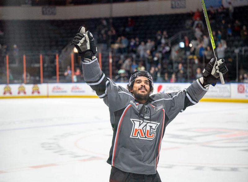 Kansas City Mavericks defenseman Koletrane Wilson celebrates with the fans after defeating the Utah Grizzlies 5-2 Friday at Cable Dahmer Arena.