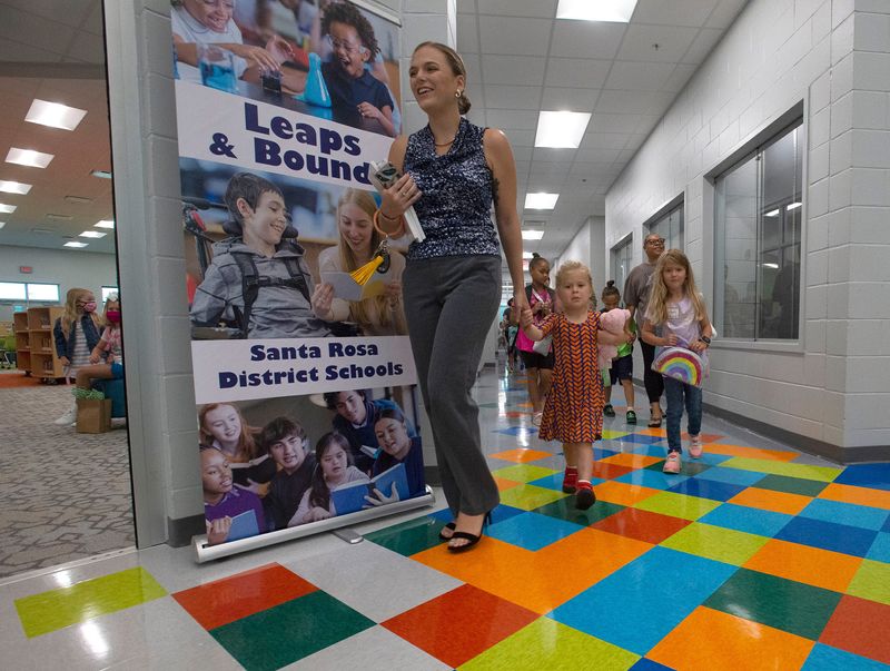 Students arrive for classes on the first day of school at the new East Bay K-8 school in Santa Rosa County on Tuesday, Aug. 10, 2021.