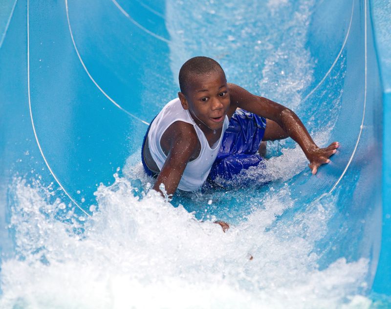 Benjamin Miller, 8, of Mount Dora, FL, anticipates hitting the pool of water on one of the water slides Saturday. Both adults and children enjoyed the water slides and wave pool at Wild Waters Saturday afternoon, July 2, 2016. The park is open every day from 10 a.m. to 6 p.m. until September 5th. Ticket prices are $15 Adults $13 for Marion County residents, kids 4-10 $9 and kids 3 and under are free. A Slip and Slide Adults Only events are every Friday night where they have live music and a bar. (Doug Engle/Ocala Star-Banner)2016