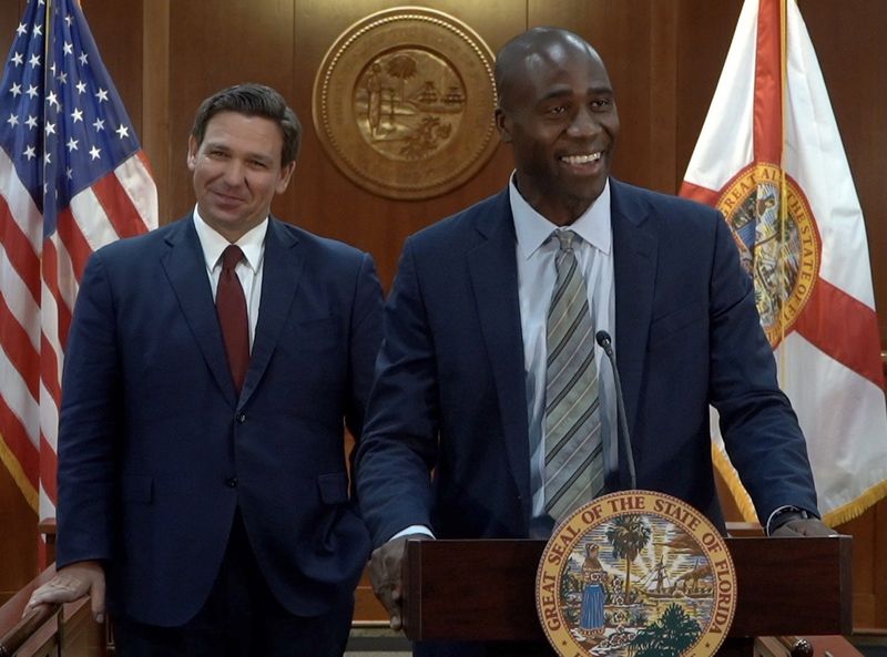 Joseph Ladapo, right, speaks after being appointed as Florida's surgeon general by Gov. Ron DeSantis, left, in September 2021.