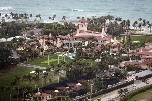 An aerial photo of The Mar-a-Lago Club shows three single-family houses — at the far left, next to the club property — owned by entities linked to President Donald Trump.