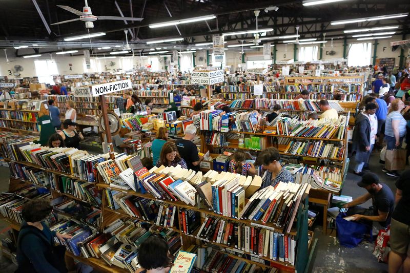 People walk through the isles and carry stacks of books during the annual Friends of the Library Book Sale in Gainesville on Oct, 19, 2019. This year's Spring Book Sale will be held April 18-22 at the Friends of the Library Book House at 430 N. Main St.