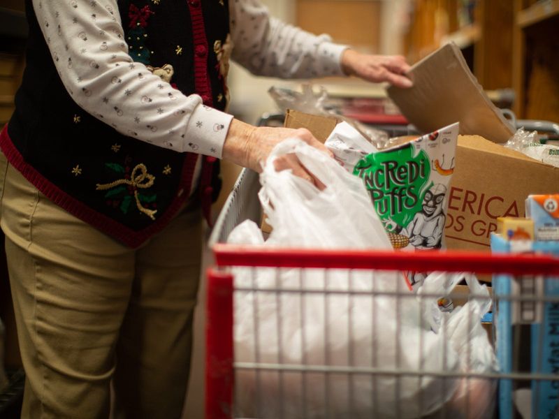 A shopping cart filled with groceries is shown at the St. Vincent de Paul food pantry.