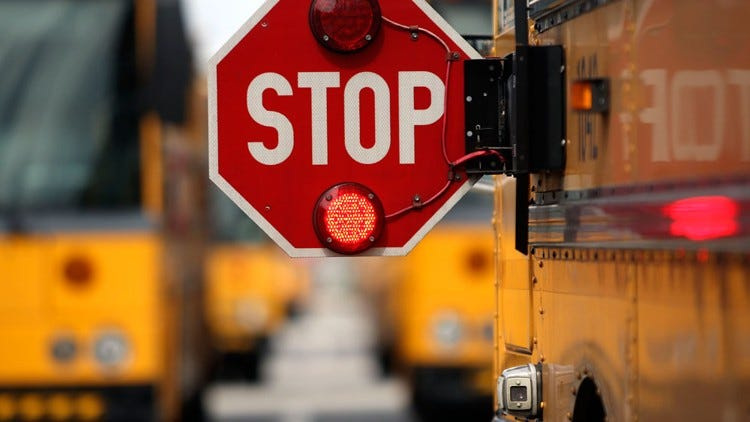 A school bus in Palm Beach County extends its stop sign. (file photo)