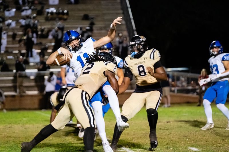 Buchholz Bobcats Myles Graham (2) sacks Bartram Trail Bears Riley Trujillo (11) at Citizens Field in Gainesville, FL on Thursday, October 19, 2023. [Chris Watkins/Gainesville Sun]