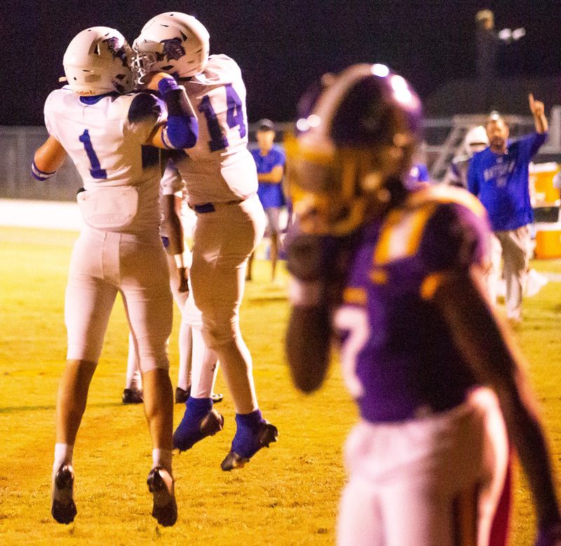 Belleview’s Nick Mills (14) celebrates a touchdown in the first half with teammate Belleview Rattlers Michael Henderson (1). The Lake Weir Hurricanes hosted the Belleview Rattlers at Lake Weir High School in Candler, FL on Friday, October 20, 2023. Belleview lead 13-6 at the half. [Doug Engle/Ocala Star Banner]