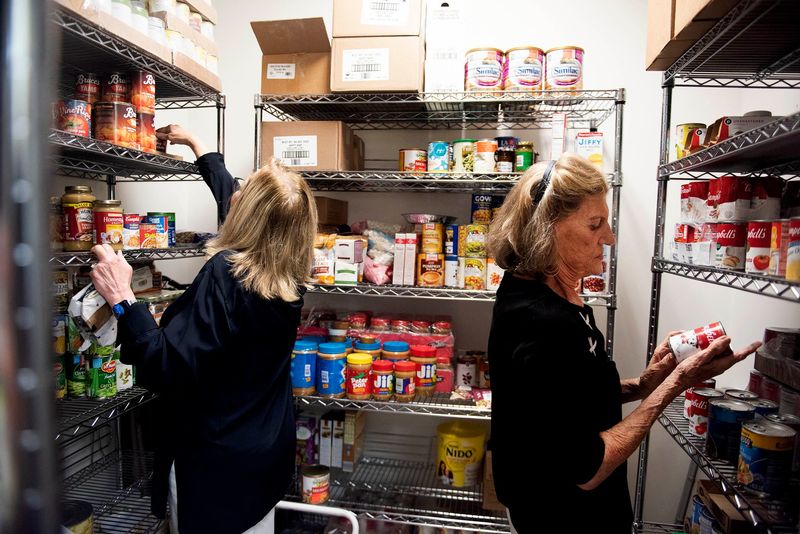 Maggie Zeidman, left, and Sylvia James sort canned goods in a pantry at the Adopt-A-Family Program Reach shelter during the Palm Beach Fellowship of Christians and Jews' Fellowship Friday on Nov. 24, 2023, in West Palm Beach. Fellowship Friday returns this year with organized in-person service projects.