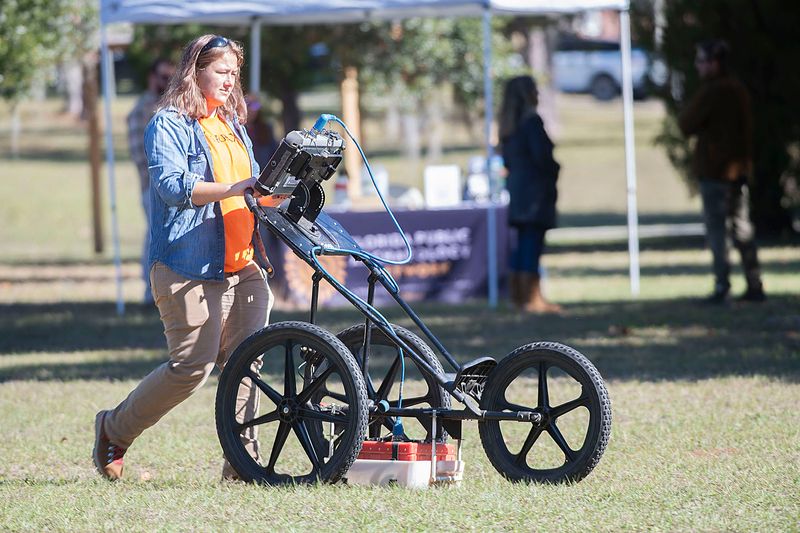 Kylie Dillinger of TerraXplorations uses ground penetrating radar to map Miraflores Park on Wednesday, Nov. 29, 2023. The city of Pensacola contracted with the company to provide a detailed survey of the land that may be a lost African-American cemetery.