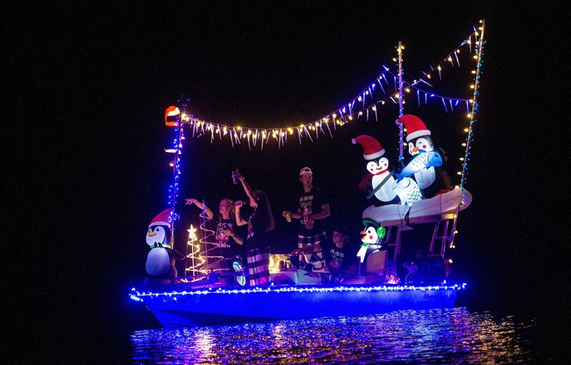 Boats participate in the annual Fort Myers Beach Christmas Boat Parade on Saturday, Dec. 2, 2023. The event was cancelled last year due to Hurricane Ian. People lined the shores and bridge to watch the annual event.