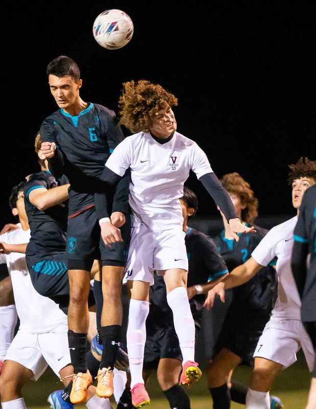 West Port Wolf Pack Gabriel Mirza (6) heads the ball above Vangaurd Knights Jassiel Quinonez (10). The West Port Wolf Pack played the Vanguard Knights in the MCIAC Boys Soccer Playoffs at Belleview High School in Beleview , FL on Thursday, January 11, 2024. [Doug Engle/Ocala Star Banner]